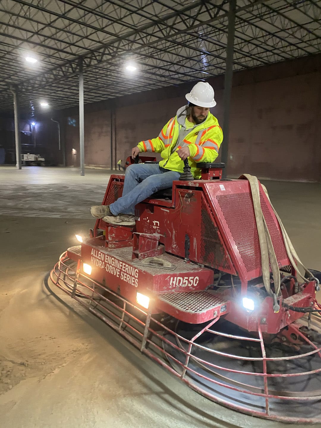 Man smoothing out concrete floors with hydra-drive