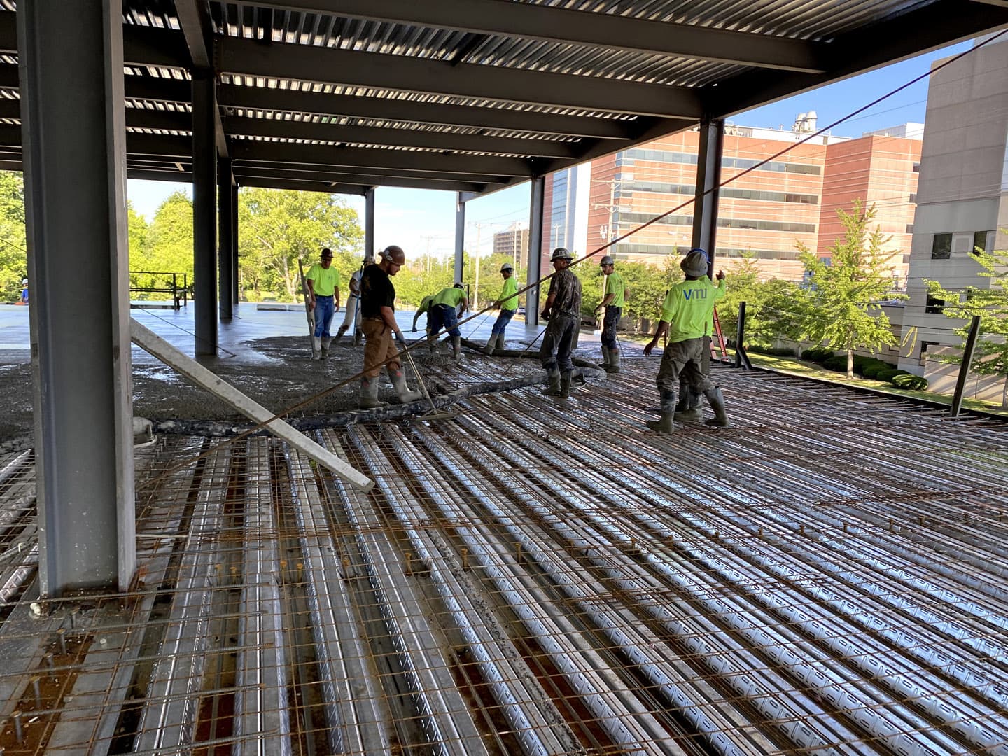 Workers laying concrete flooring